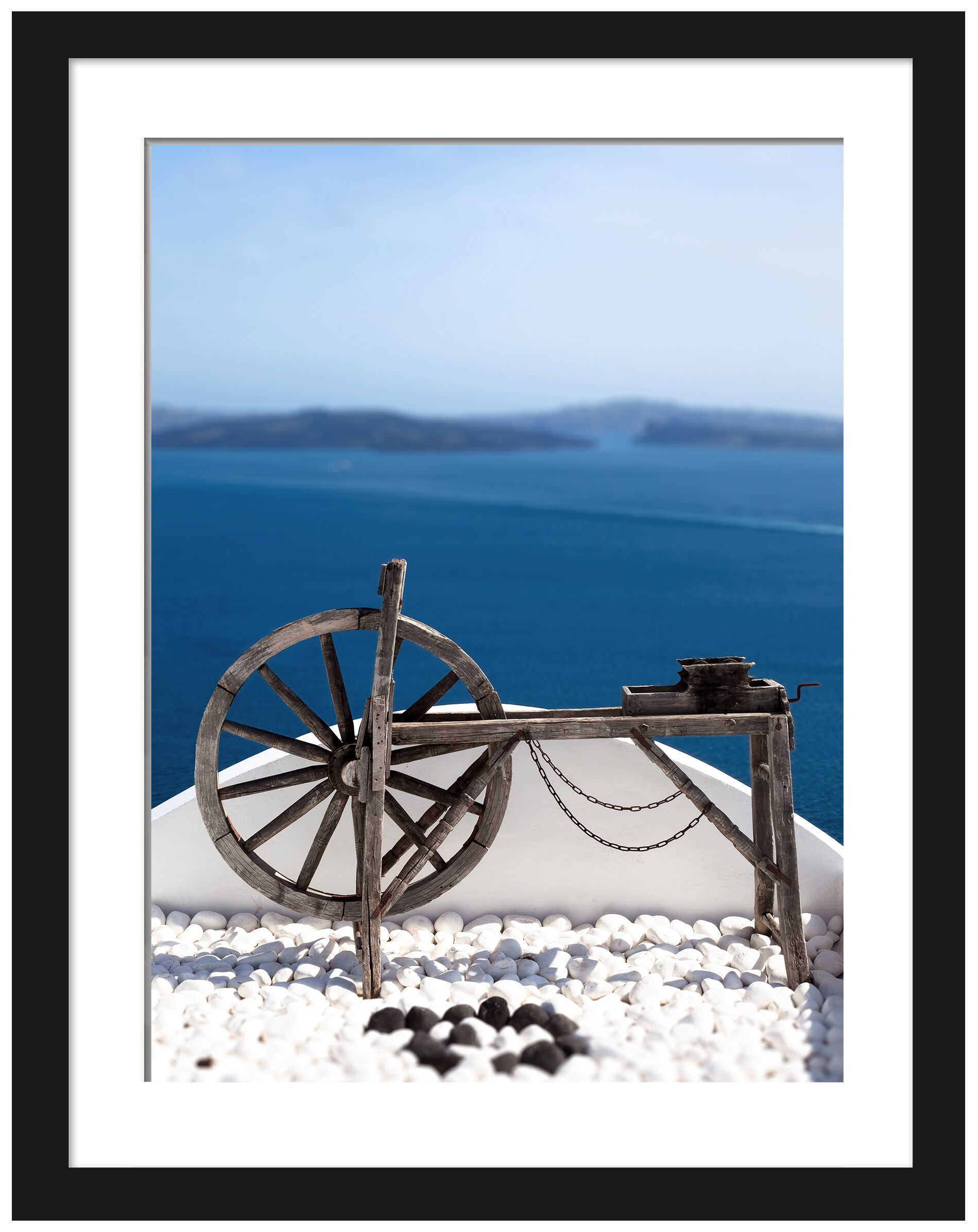 Old wooden spinning wheel overlooking the ocean in Santorini, Greece